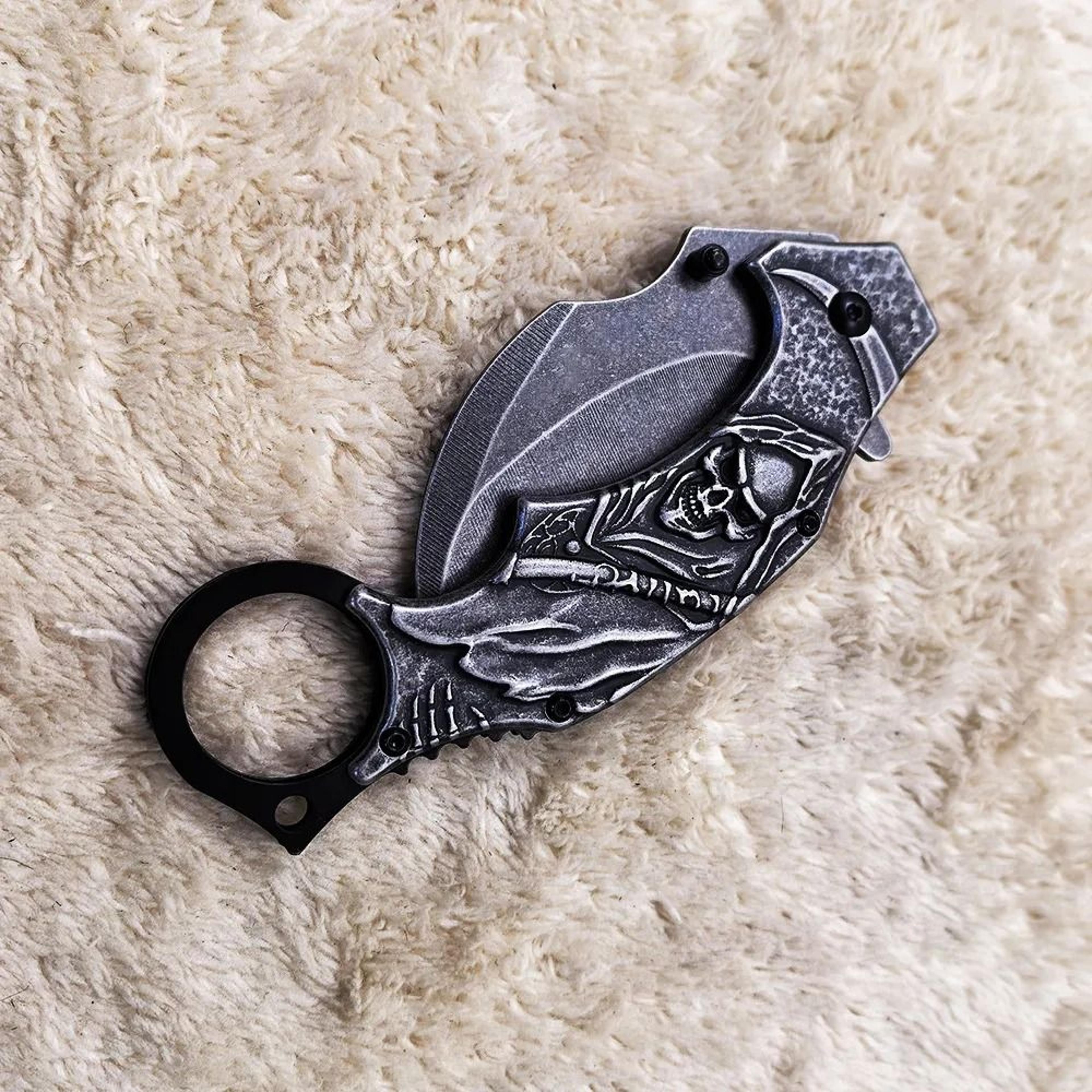 folding knife with stonewash blade and stainless steel skull handle
