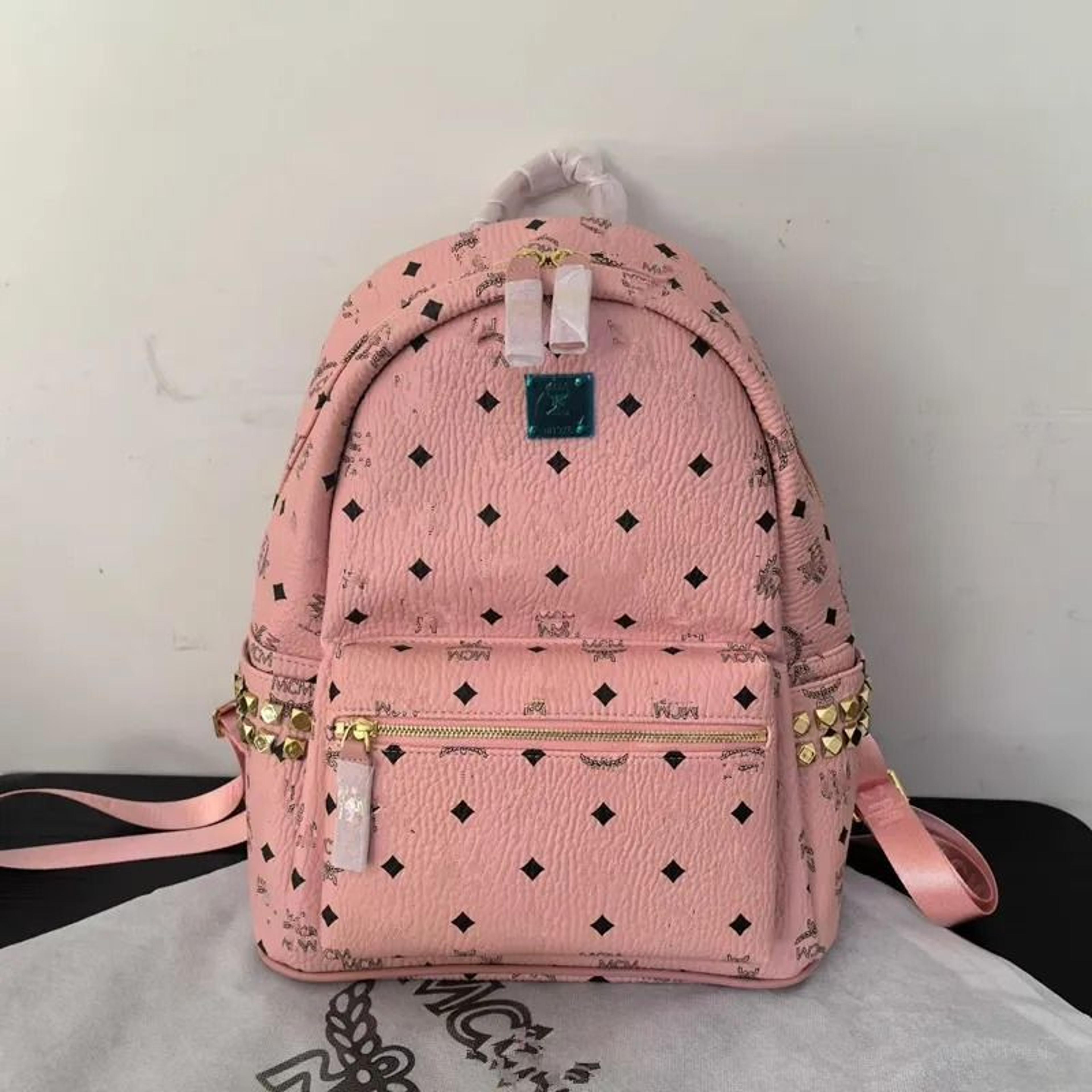 studded cognac brown backpack with monogram and pyramid rivet detail