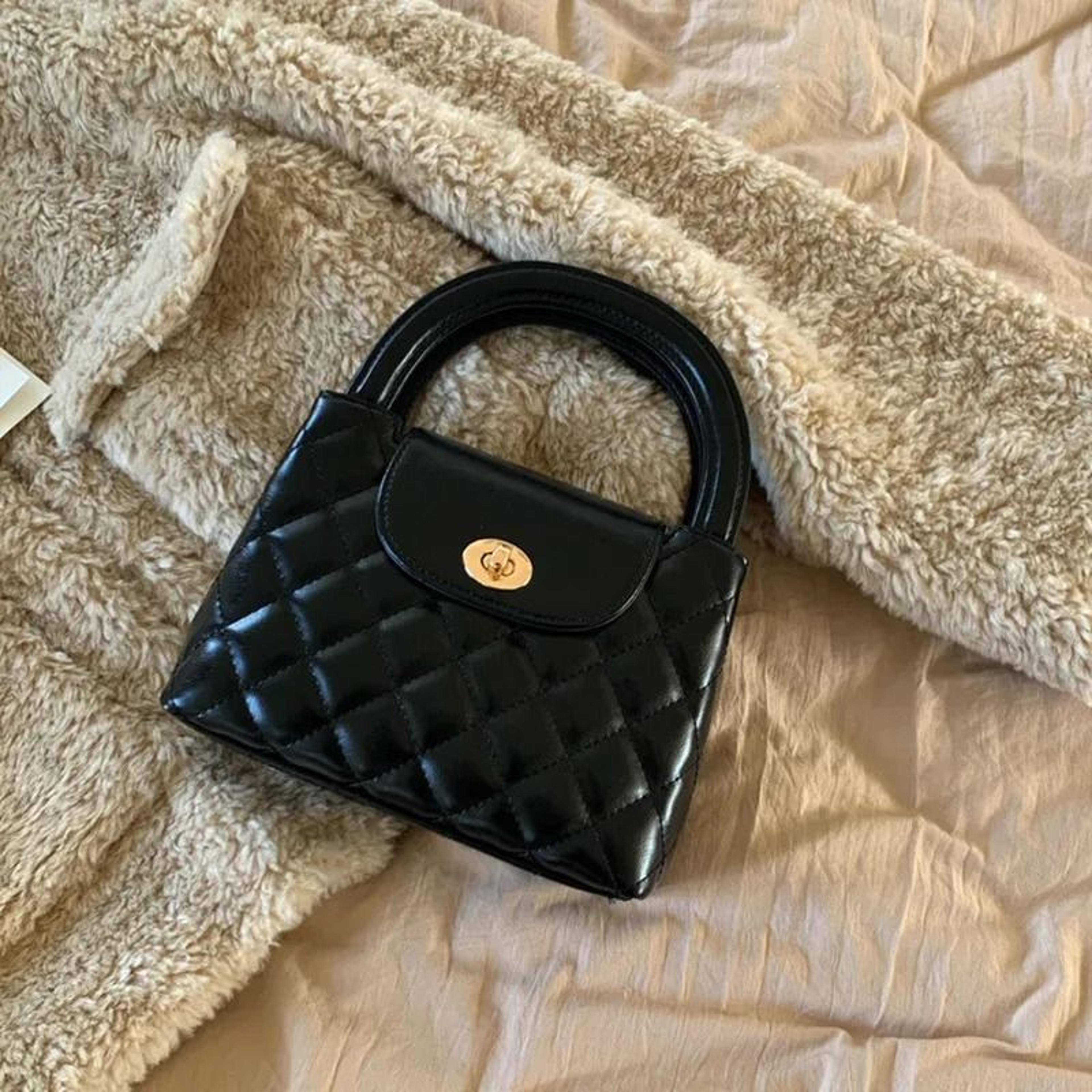 quilted handbag with top handle and adjustable crossbody strap