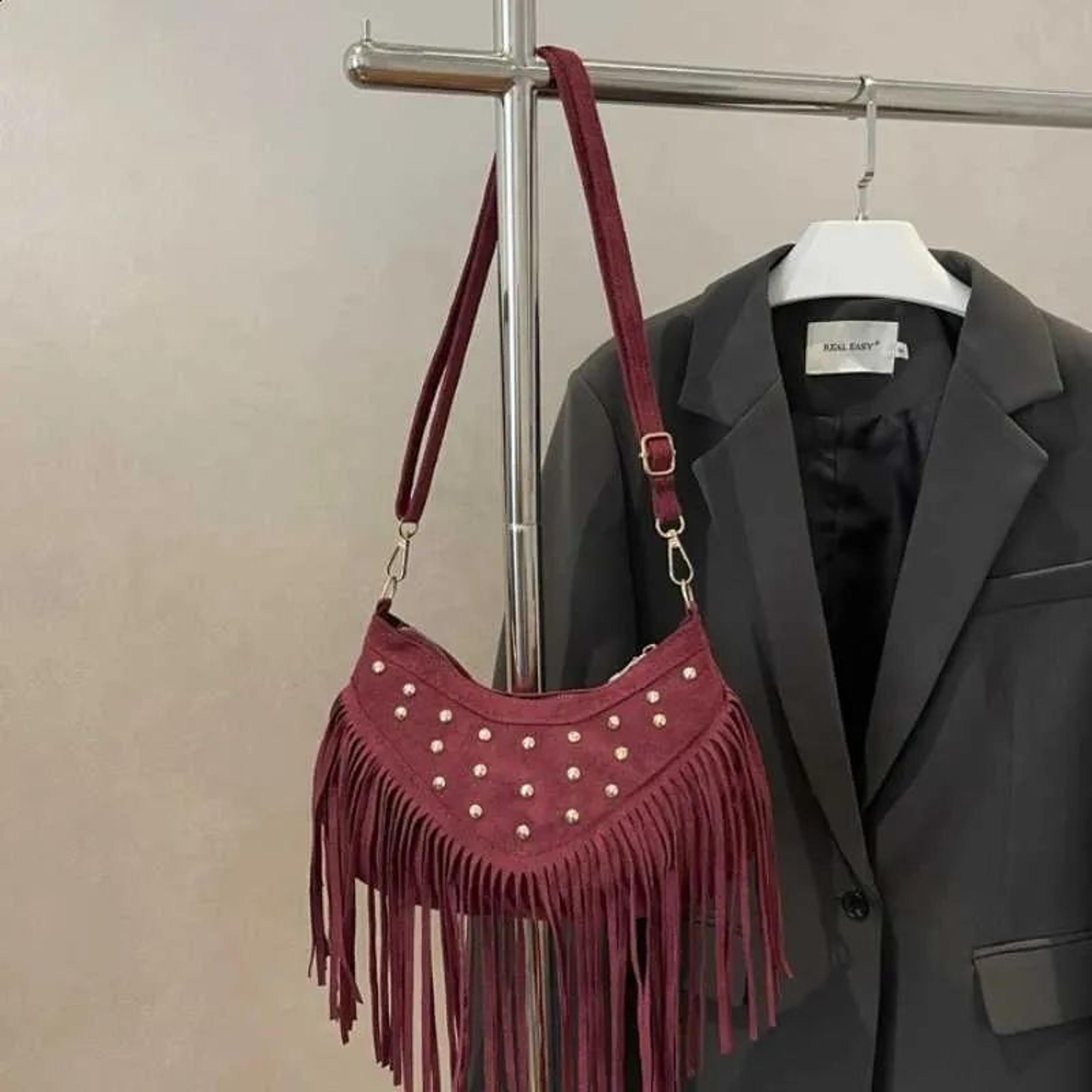 suede fringe shoulder bag with metal studs and vintage crescent design