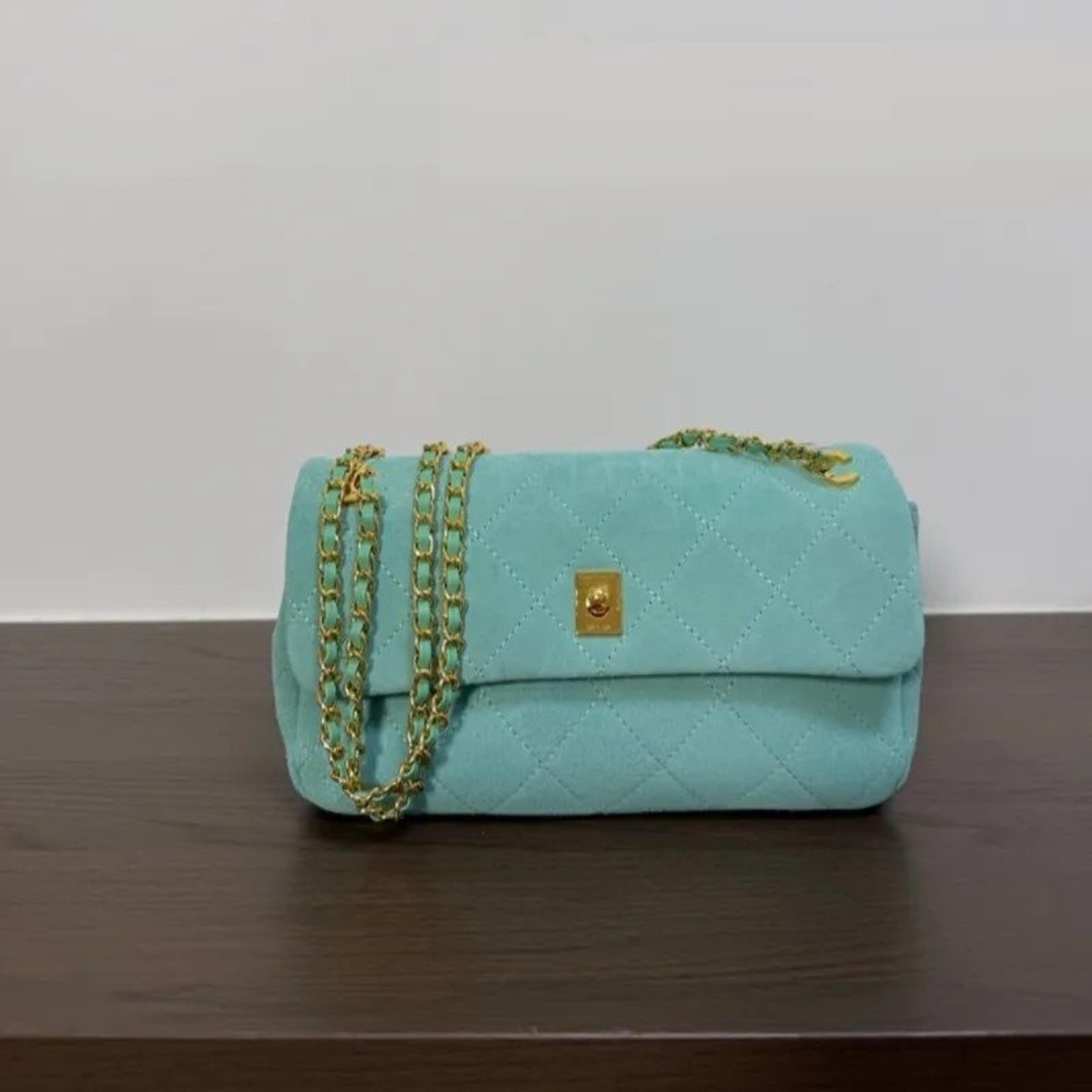 womens turquoise quilted suede crossbody bag with gold chain straps