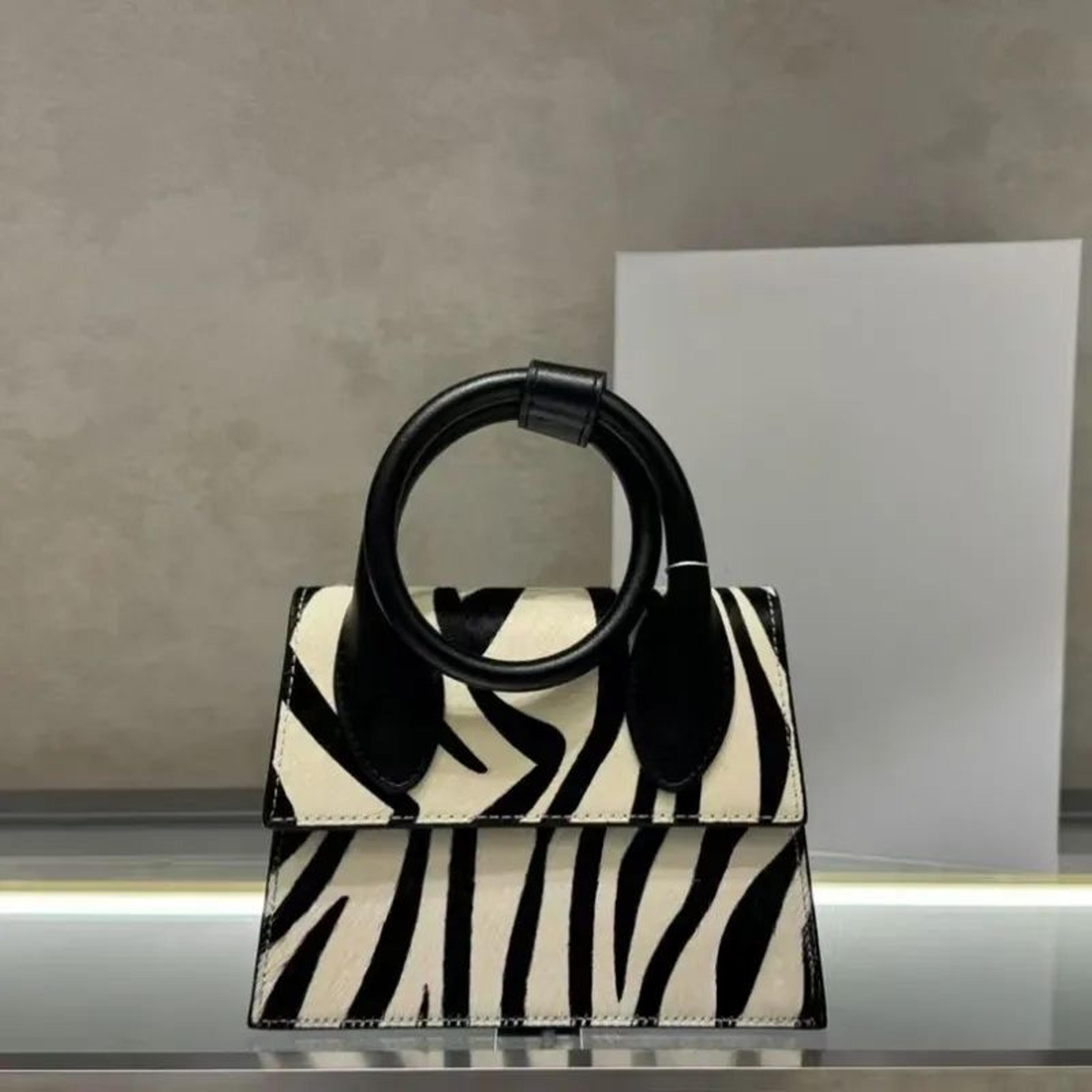 genuine leather zebra print shoulder bag with flap and hasp closure