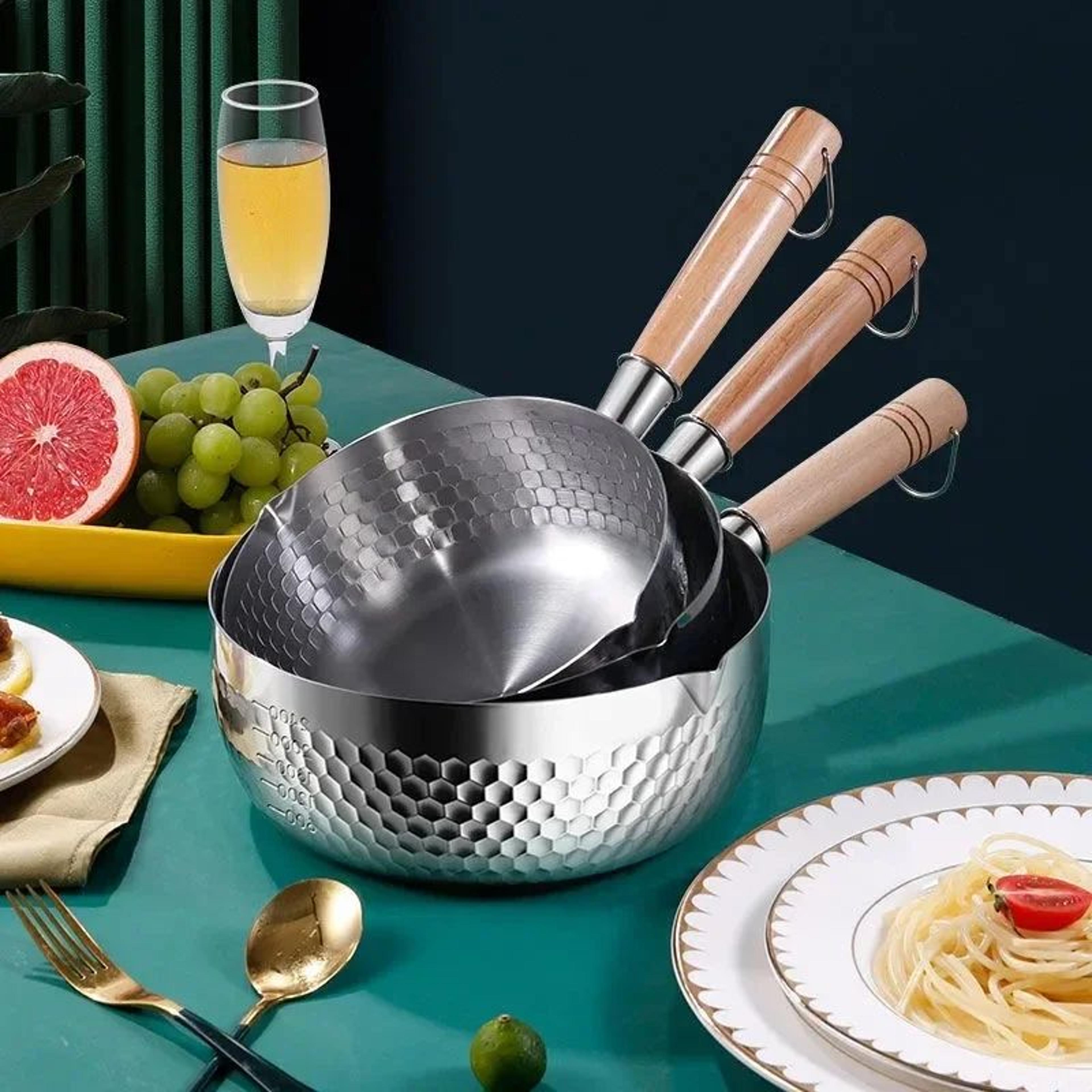 stainless steel saucepan with wooden handle and pour spouts