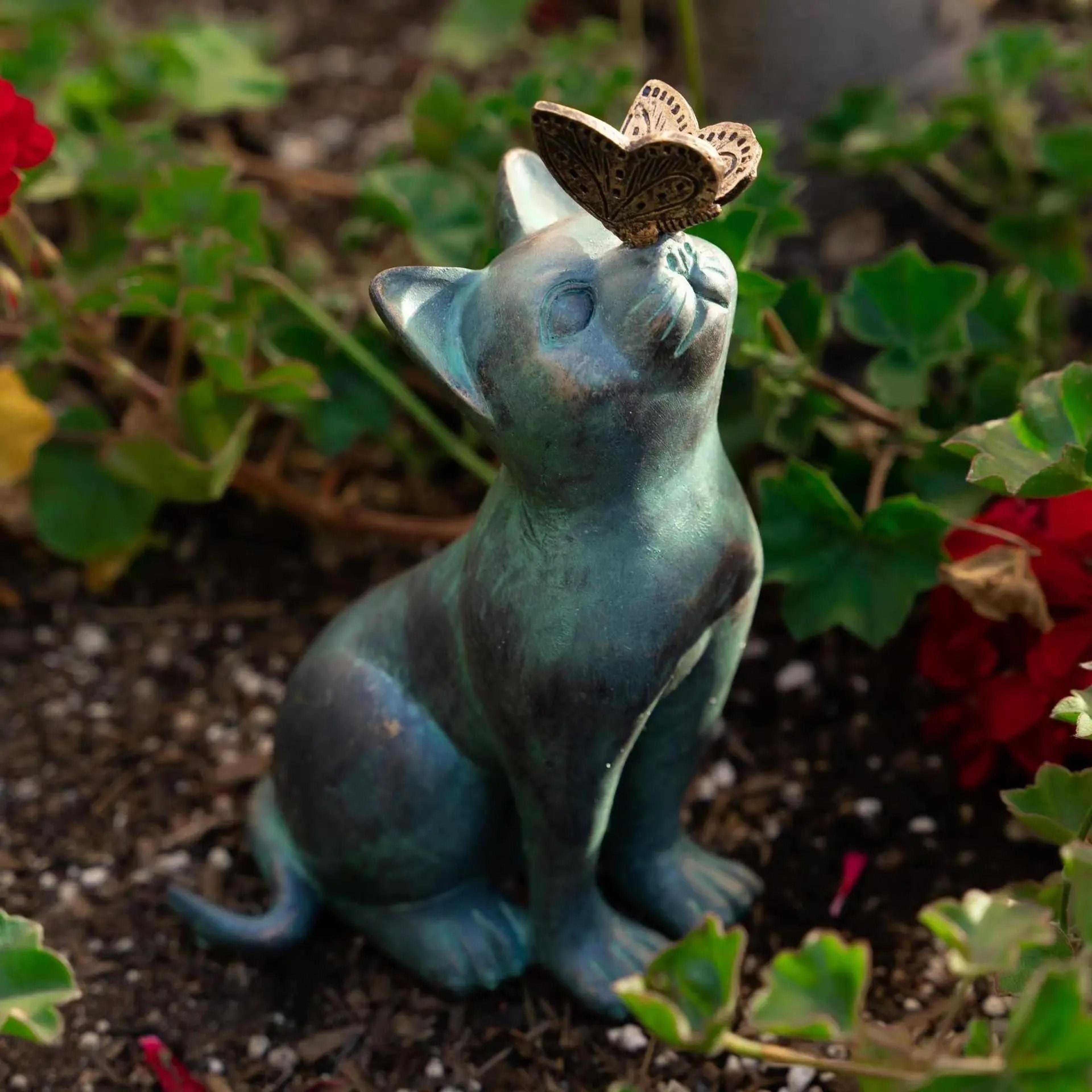 whimsical cat and butterfly garden statue