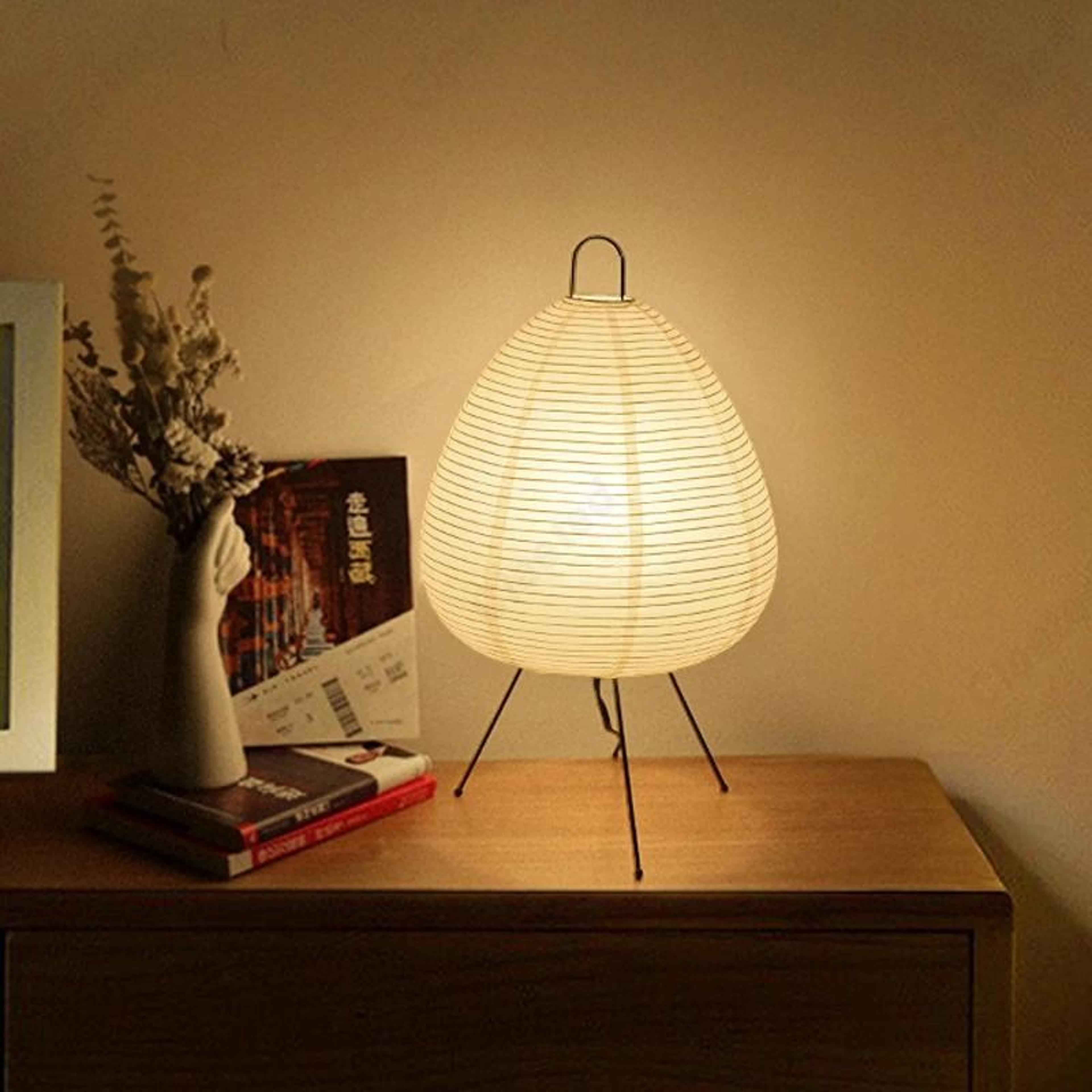 japanese rice paper tripod table lamp creates warm serene bedroom ambiance