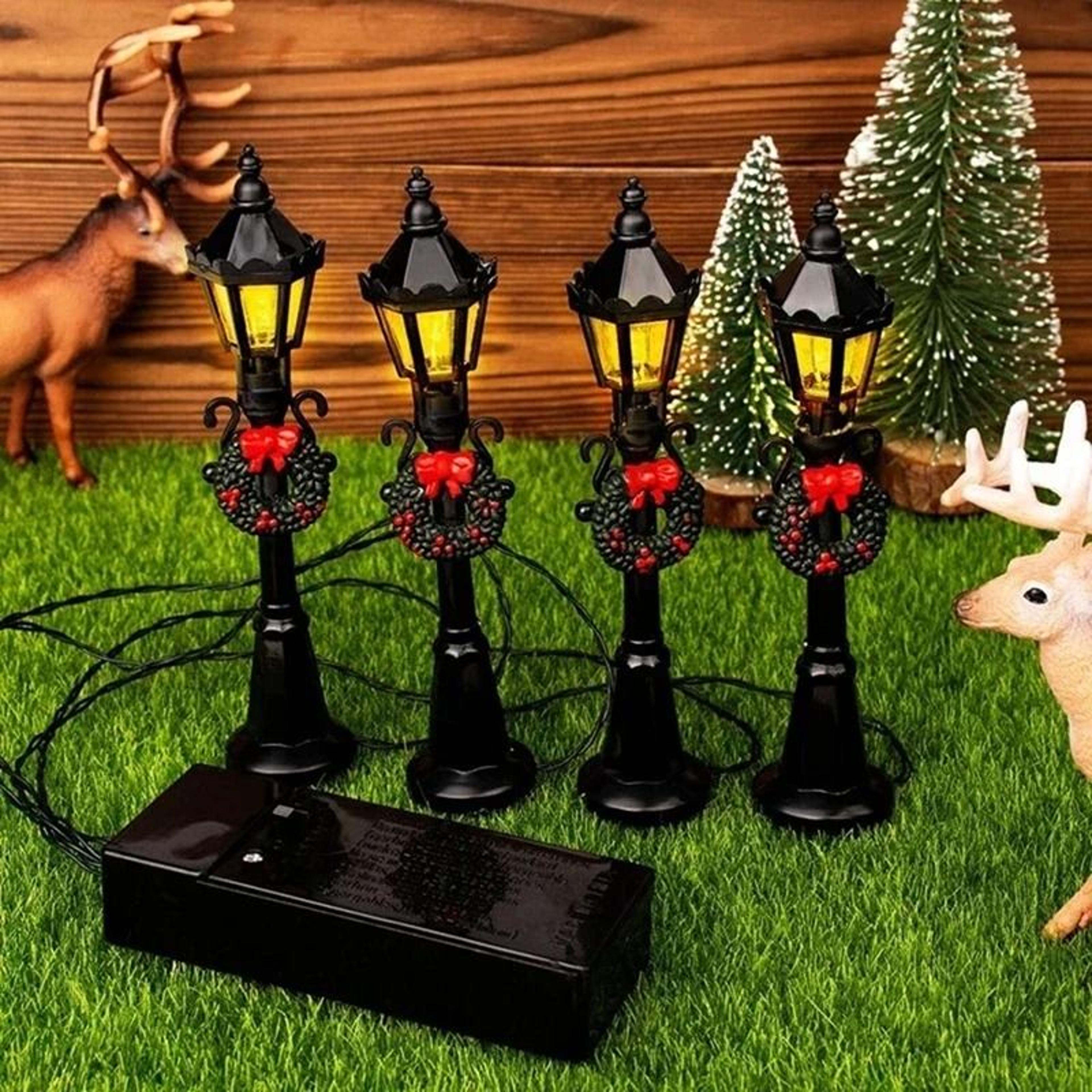 miniature christmas street lights bring cozy detail to tiny village displays