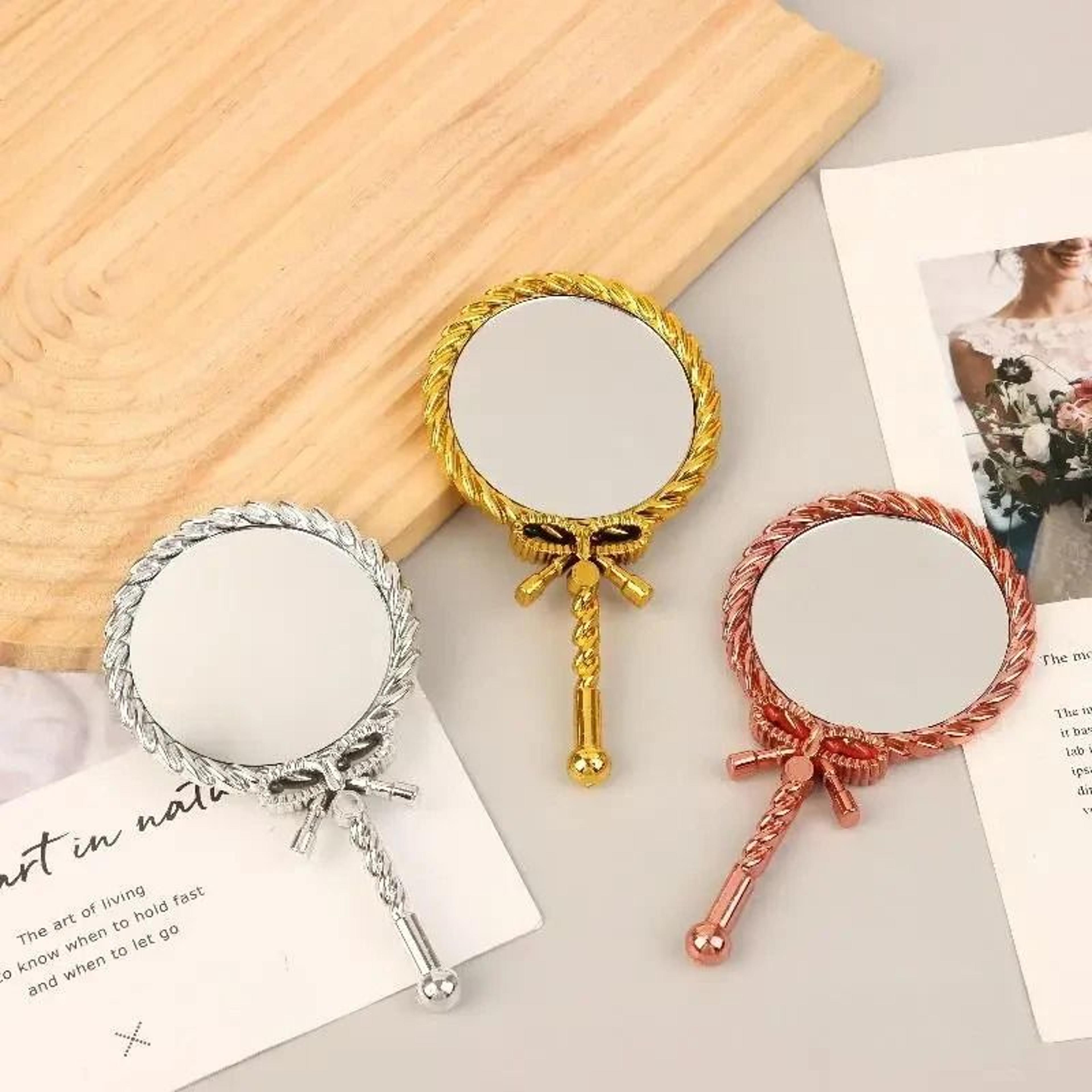 elegant round handheld makeup mirror for portable beauty and grooming use
