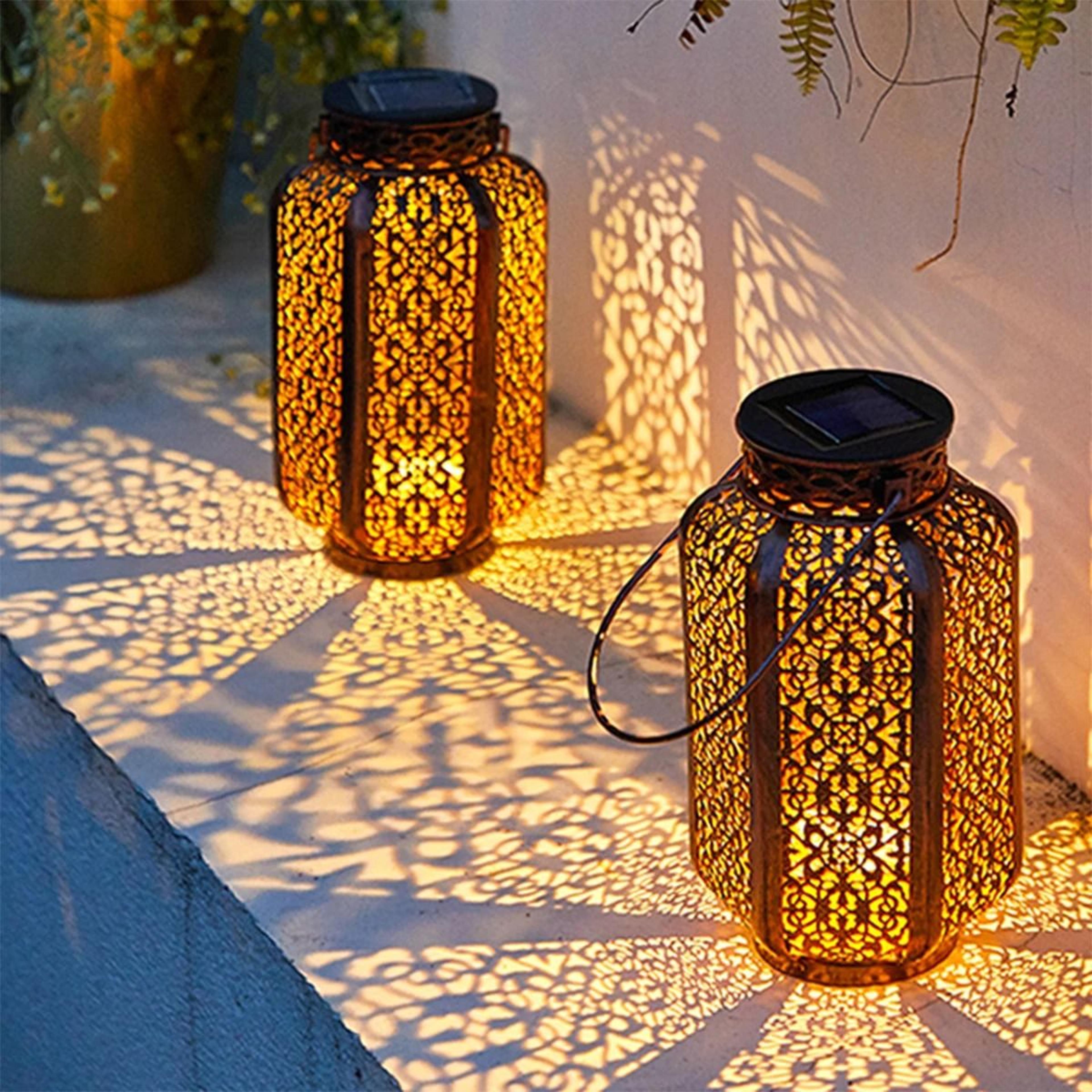 solar hanging iron lantern casts vintage patterns across gardens patios pathways