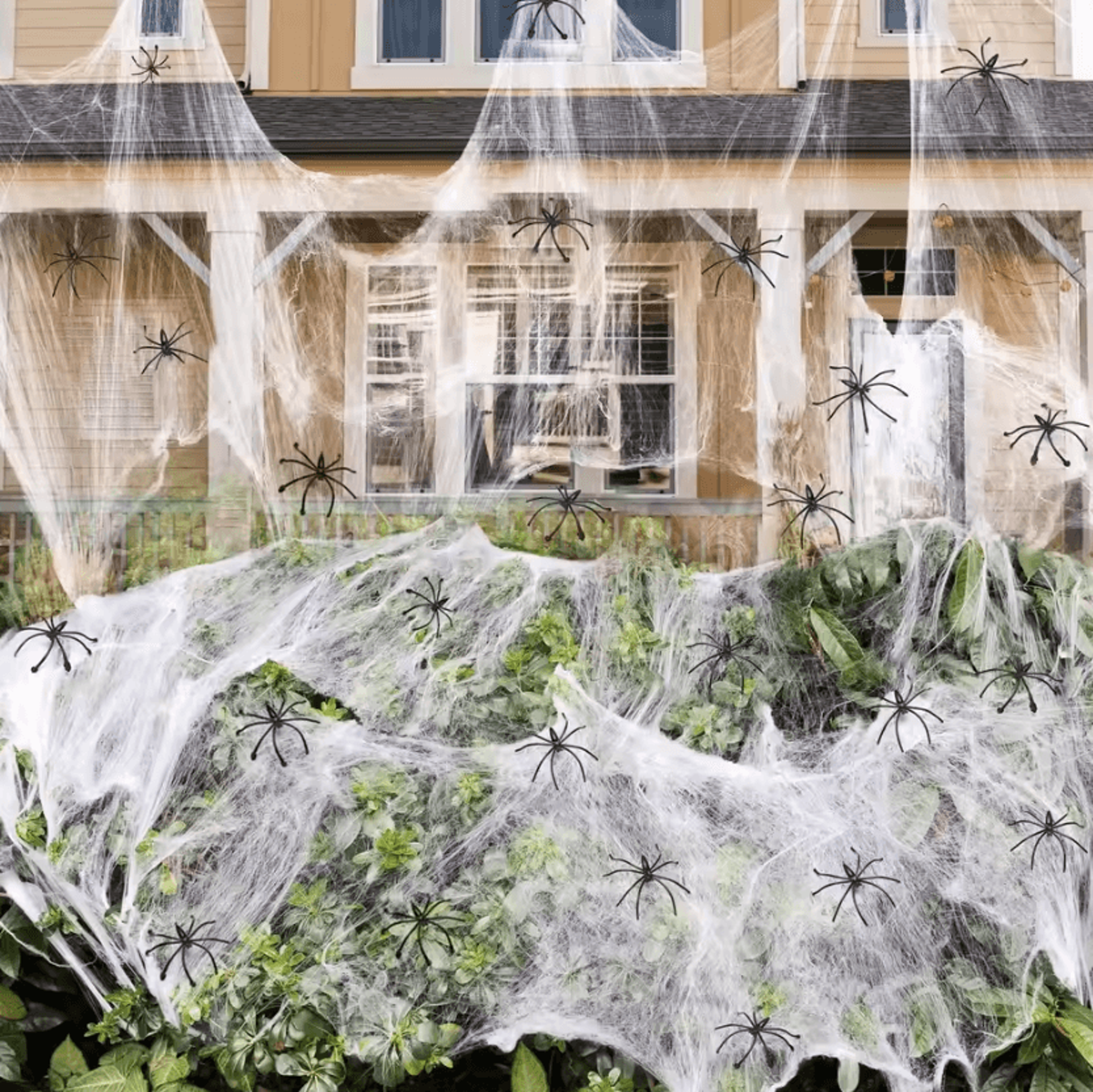 white stretch halloween spider web decoration with fake cobweb effect