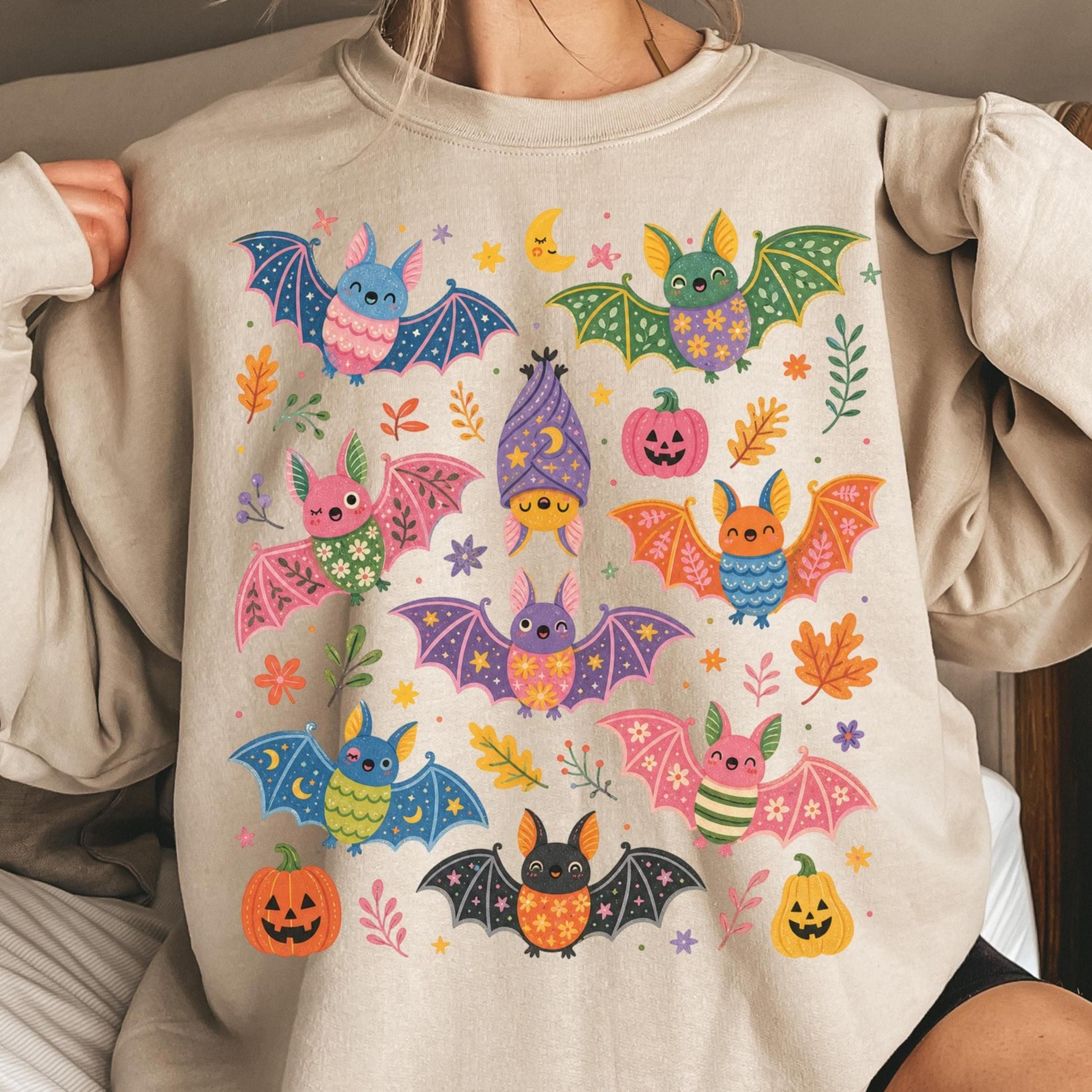 cute bat halloween sweatshirt, spooky season crewneck, floral bat graphic pullover, fall whimsical sweatshirt