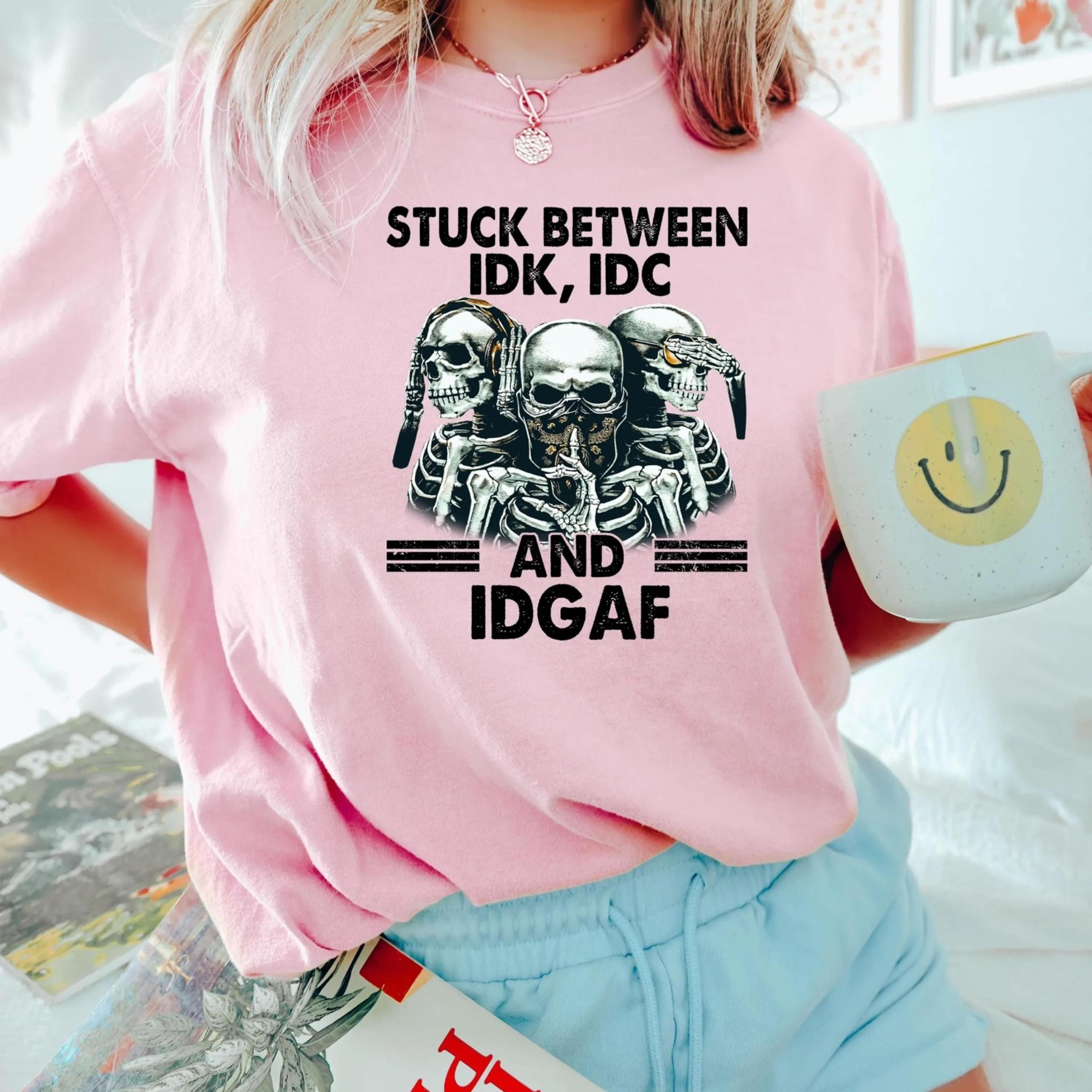 stuck between idk, idc and idgaf funny skeleton gang shirt, skeleton graphic hoodie, skeleton lover sweatshirt, skeleton
