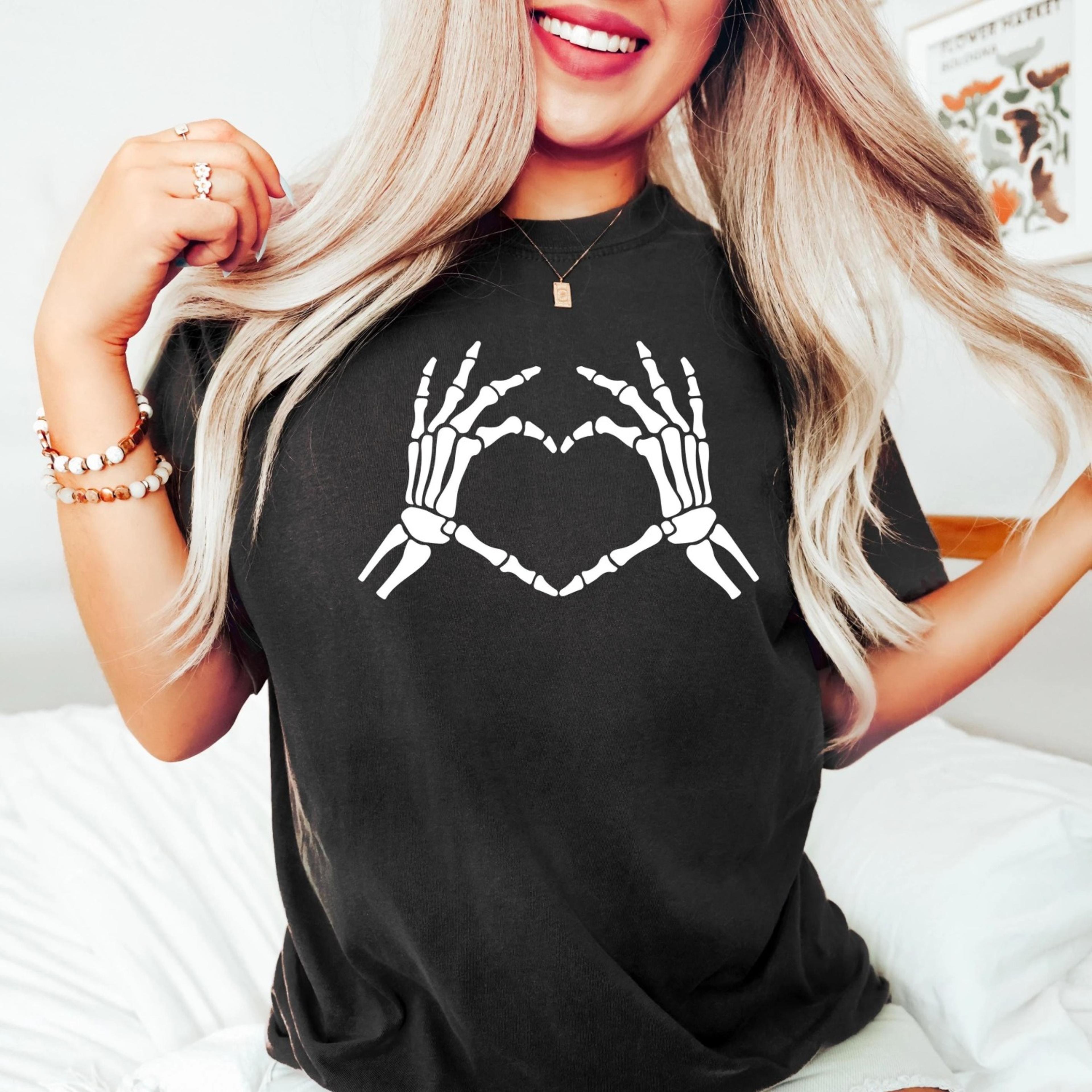 skeleton hand making heart shirt, spooky halloween heart shirt, scary halloween skeleton shirt