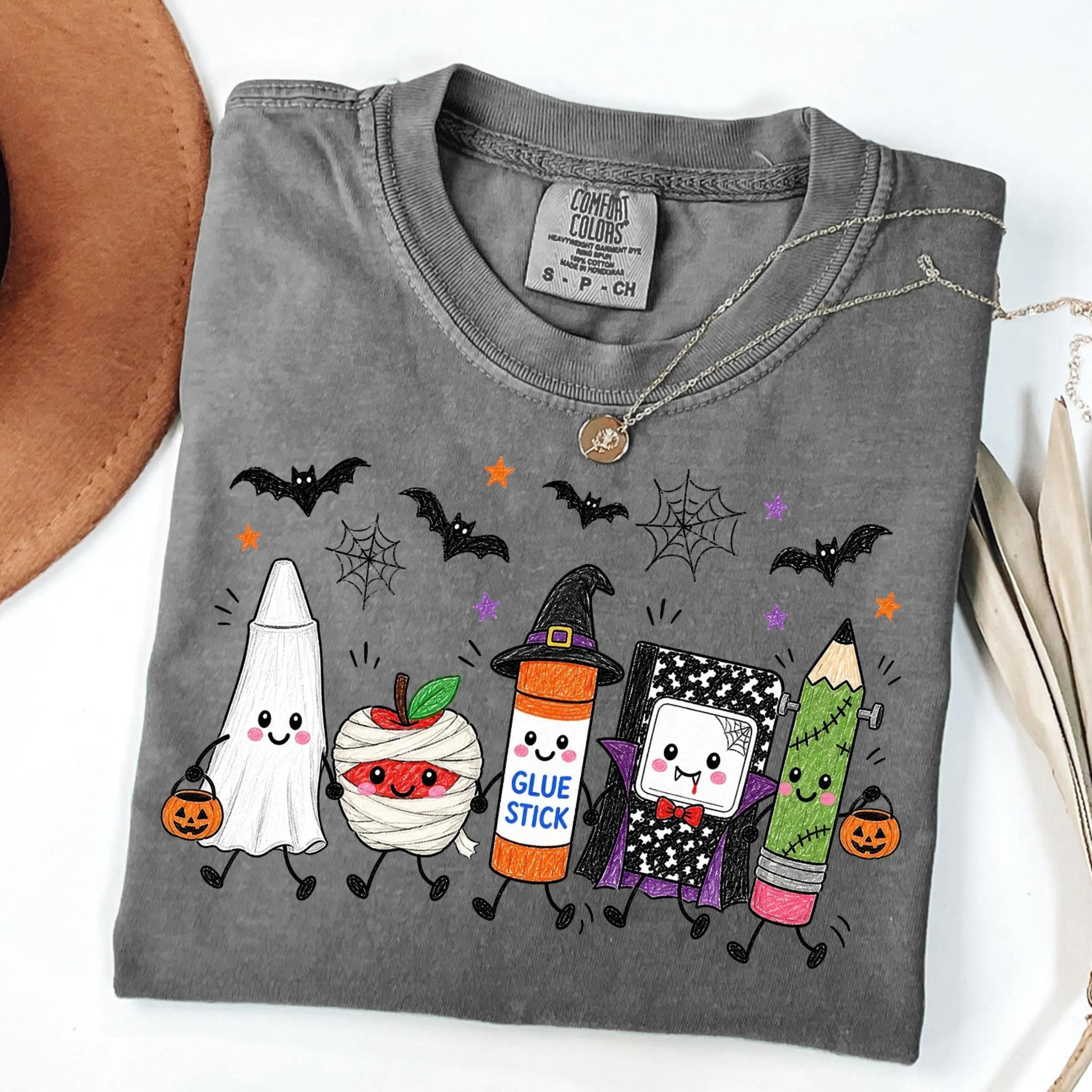 halloween teacher shirt, spooky school supplies graphic shirt, cute ghost classroom apparel