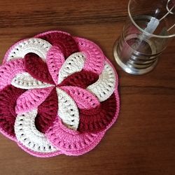 Round pink napkin, a stand for hot food.