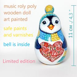 A cute penguin with a heart of roses . An amazing souvenir gift . Roly poly toy , Musical toy