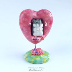 gray djungarian hamster figurine in the pink heart stand