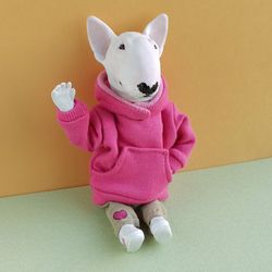 A bull terrier doll in pink sweater