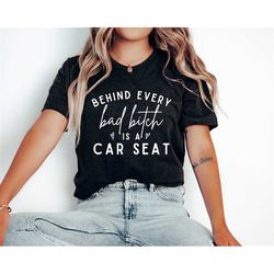 funny mom shirt, toddler mom shirt, behind every bad bitch is a car seat, mom life shirt, unisex t-shirt