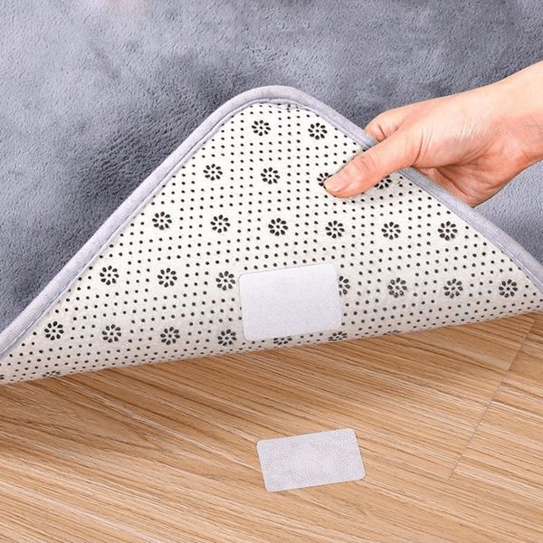 Person pulling a rug up from a Velcro pad.