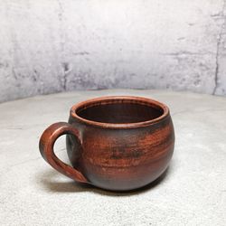 Handmade ceramic mug pottery made of red clay
