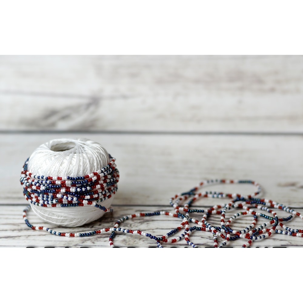 Beads strung on a thread according to the pattern