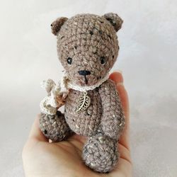Crocheted teddy bear with pendant