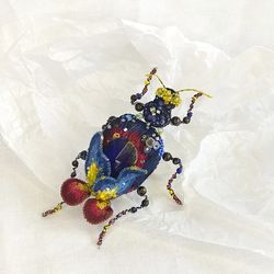 Embroidered brooch beetle Night iris. Beetle with flower and glass