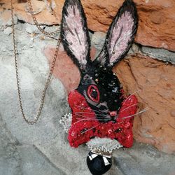 embroidered pendant or brooch with an evil rabbit