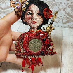 Portrait brooch June. Girl in red clothes with a little dragon