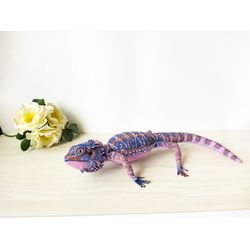 Realistic purple bearded dragon agama. Interior figurine amigurumi lizard crocheted. Handmade soft toy animal reptile.