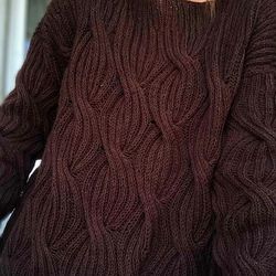 Knitted sweater for women with a lush pattern.