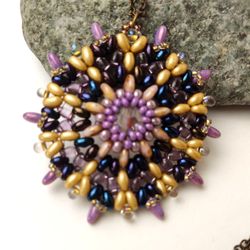 Round lilac-gold openwork beaded pendant with a faceted bead on a chain