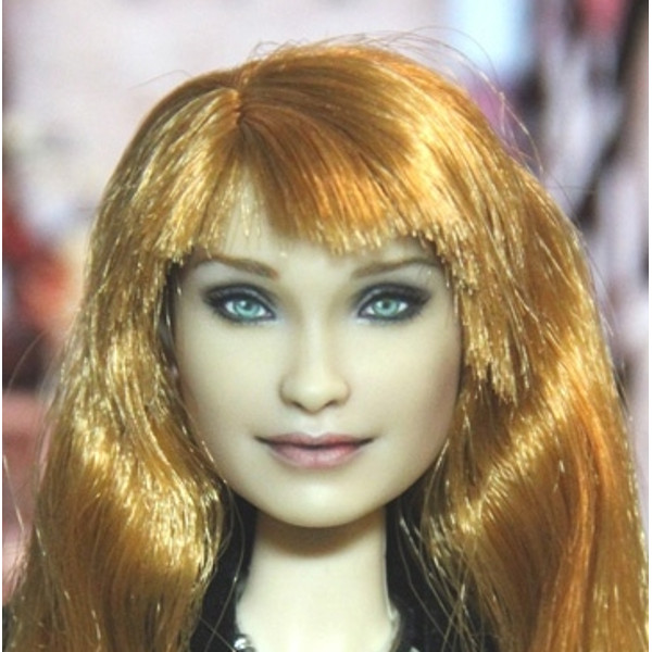 Barbie head with orange hair and green eyes