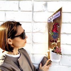 wood sign welcome with gnomes and planters for flower