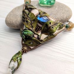 Green frog pendant with elaborete composition