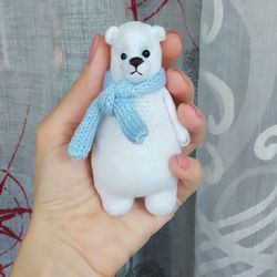 soft small toy polar bear in a scarf