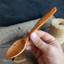 Handmade wooden spoon from natural apricot wood for eating or serving