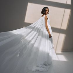 Cascading skirt wedding dress. Veil tulle bridal gown. V neckline light dress with cape.