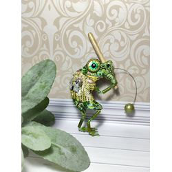 Embroidered brooch with a green frog. Number 12 with wooden bat and pearl ball.