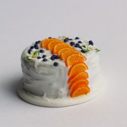 Miniature orange cake with berries, dollhouse food for dolls at 1:12 scale