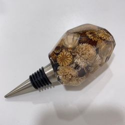 resin wine bottle stopper with embedded dried  australian gomphrena and poppy flower heads