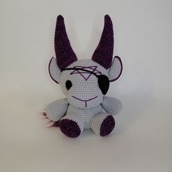 Gray crochet baphomet plush with dark purple horns in the view of a pirate - gothic gift for horror lovers