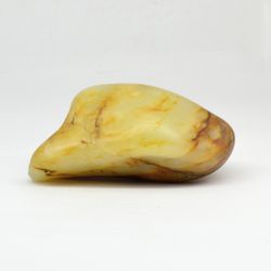 A river pebble of white jade in a brown crust
