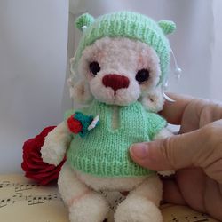 Amigurumi handmade animal bear in sweater and hat. Crochet plush bear. Collectible teddy bear. Cute crochet fluffy baby.