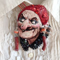 Embroidery brooch-pendant with a portrait of a witch, Baba Yaga. It's called "205 - I'm the highlight again!"