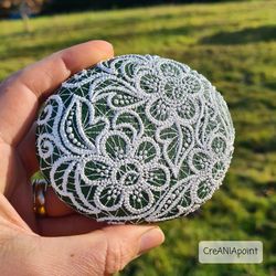 Floral line art on hand painted stone in dot painting for outside decor