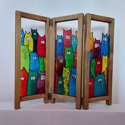 Folding table top screen/divider, wood frame and stained glass imitation.
