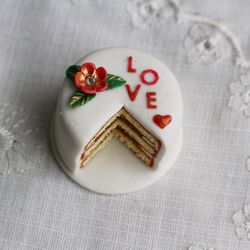 Miniature white Valentine's Day cake, dollhouse food for dolls at 1:12 scale