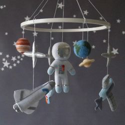 A space mobile for astronaut's nursery, a Shuttle and a rocket made of felt for the decor boy's room