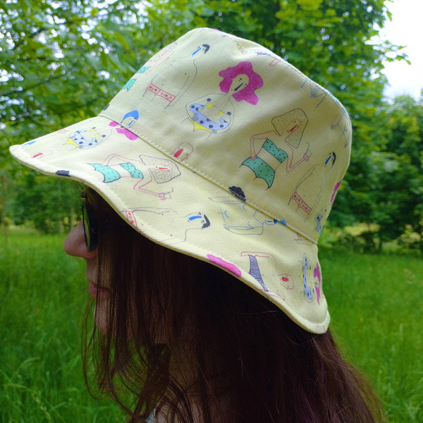 Comic cotton bucket hat for travel, beach, sun protection. Funny and cute summer clothes. Yellow designer bucket hat.